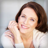 Smiling woman with smooth skin representing wrinkle reducer effect